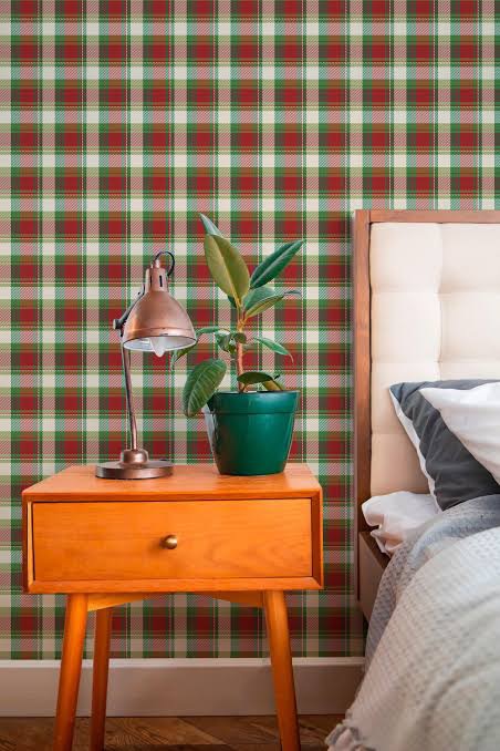 red and green christmas peel and stick wallpaper in a festive living room
