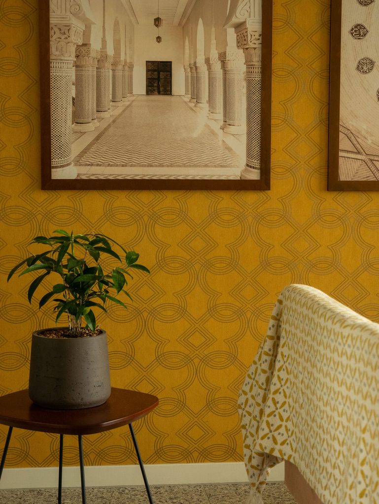 mustard yellow peel and stick wallpaper accent wall with geometric pattern
