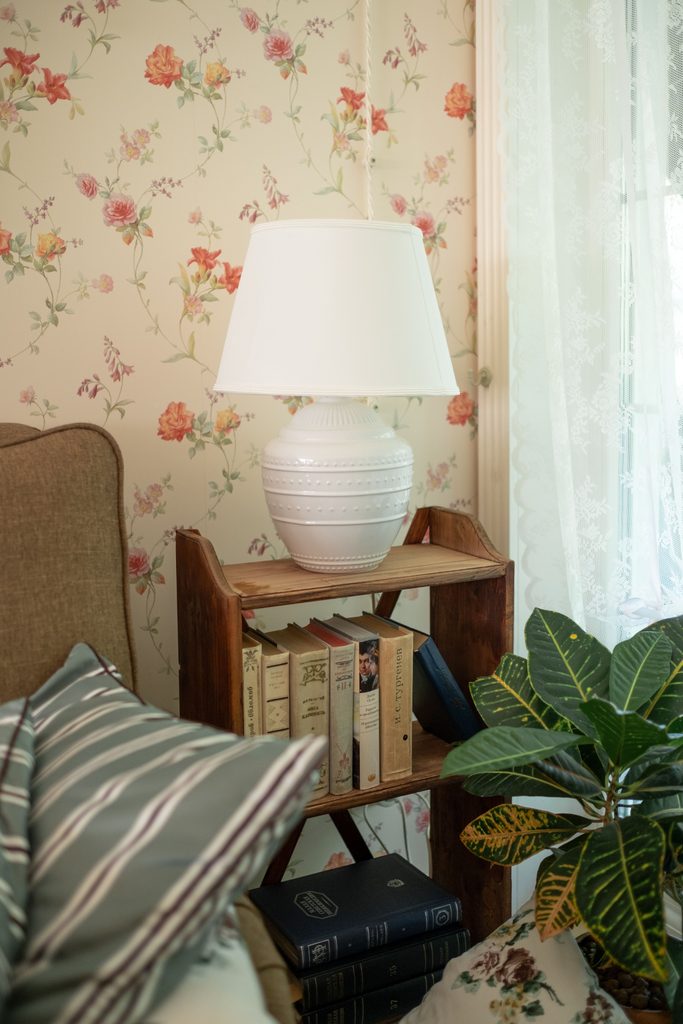 cottagecore floral peel and stick wallpaper in a cozy reading corner
